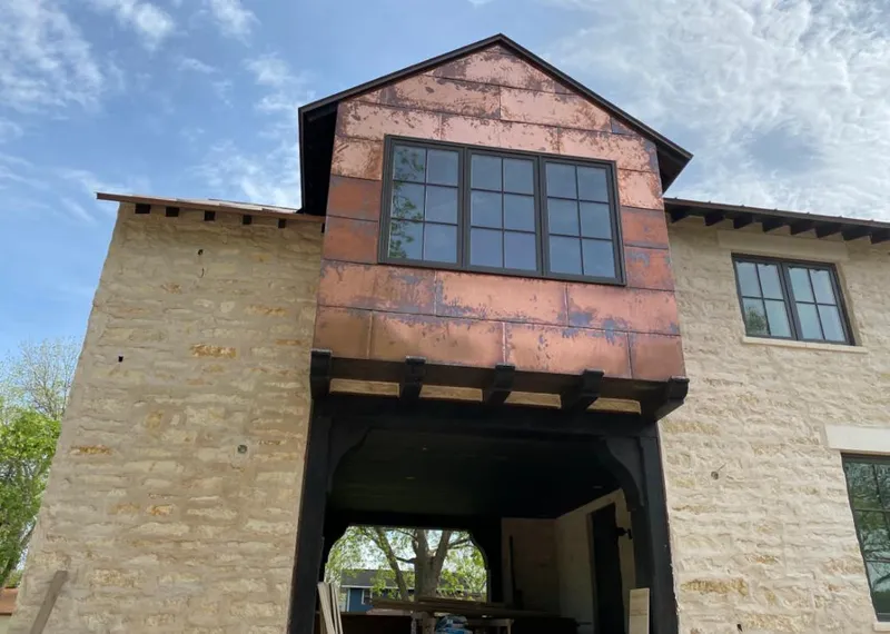 Copper metal panel facade on a stone building for Roof Repair in Miramar